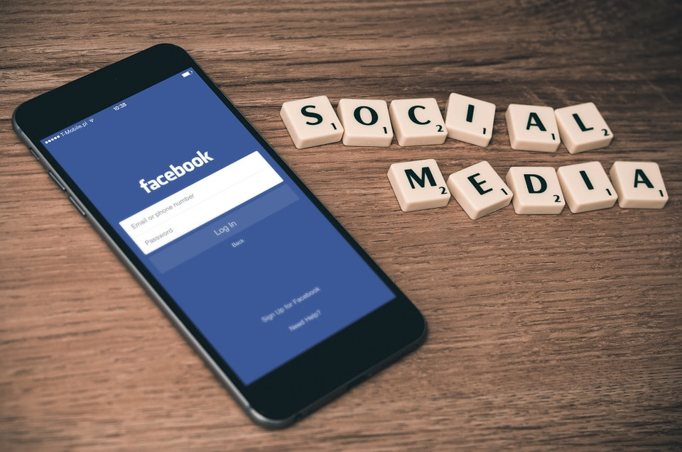 Facebook app on smartphone and social media scrabble word